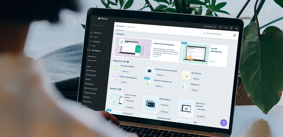 Macbook with District by Danske Bank open showing District Marketplace 