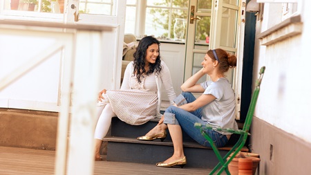 friends sitting on the front porch talking
