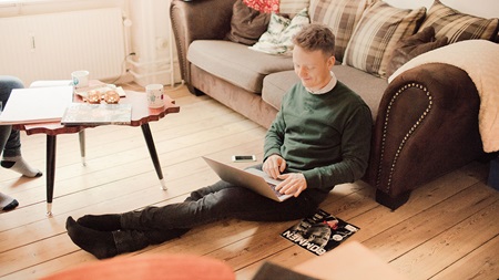 man sitting with laptop on the floor