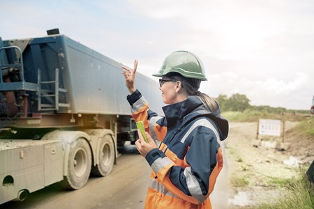 woman waving dumptruck